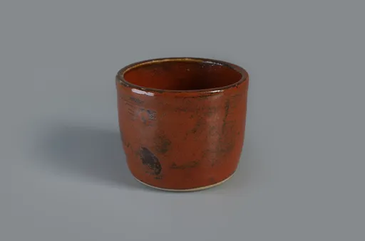 Small orange pot with darkened texture